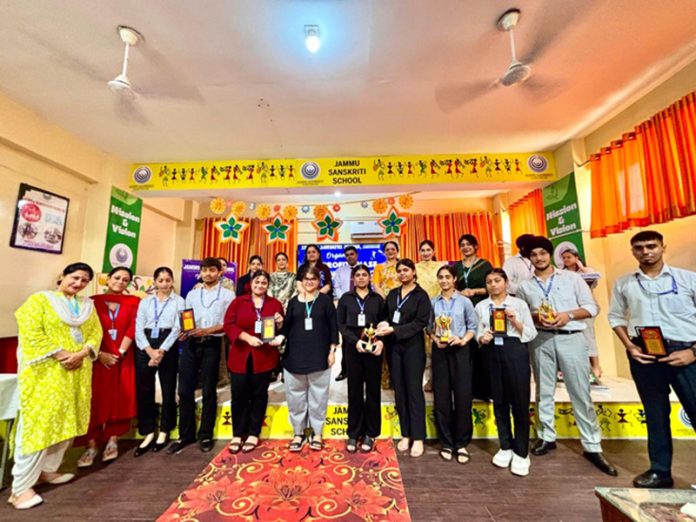 Participants posing along with trophies alongside dignitaries.