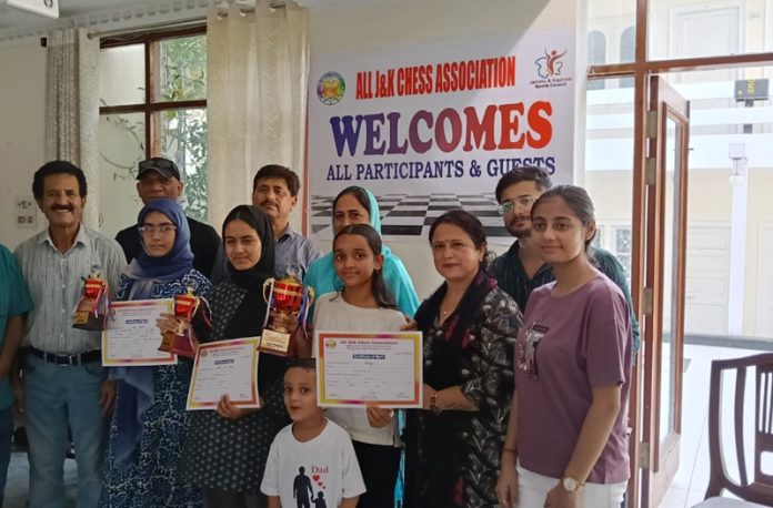 Winners of J&K UT U-13 Girls Chess Championship posing along with dignitaries.