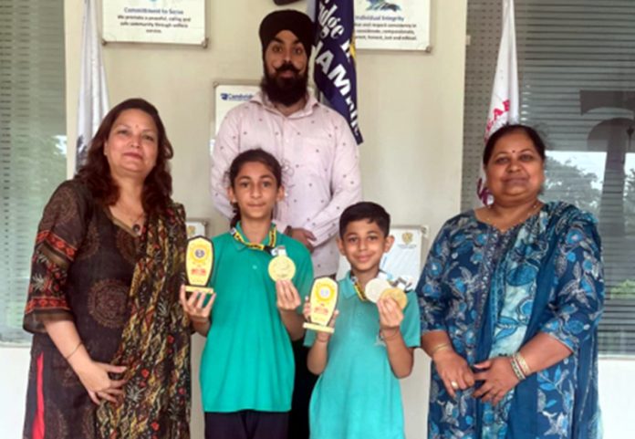 Students posing along with trophies. Students posing along with trophies.