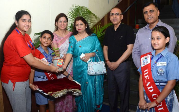 Dignitary presenting trophy to student.
