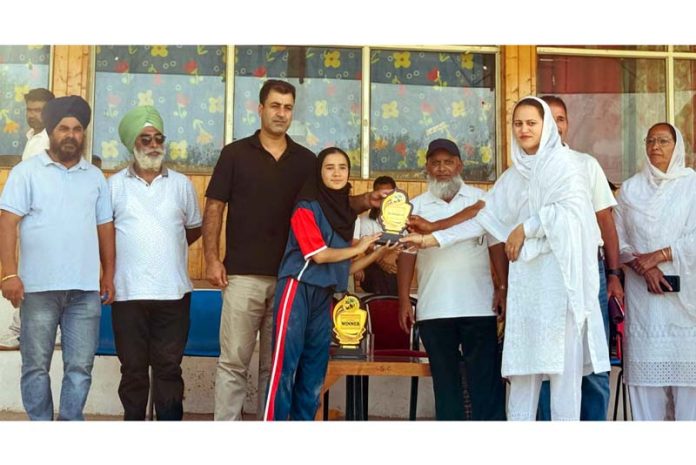 A player receiving trophy from dignitaries.