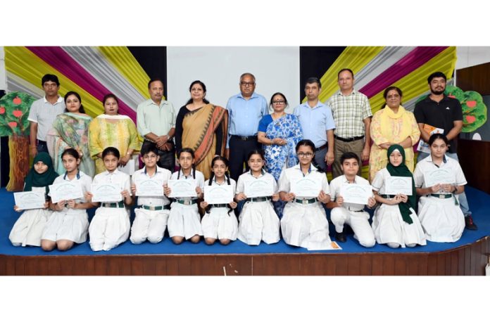 Students posing along with dignitaries during a programme. Students posing along with dignitaries during a programme.