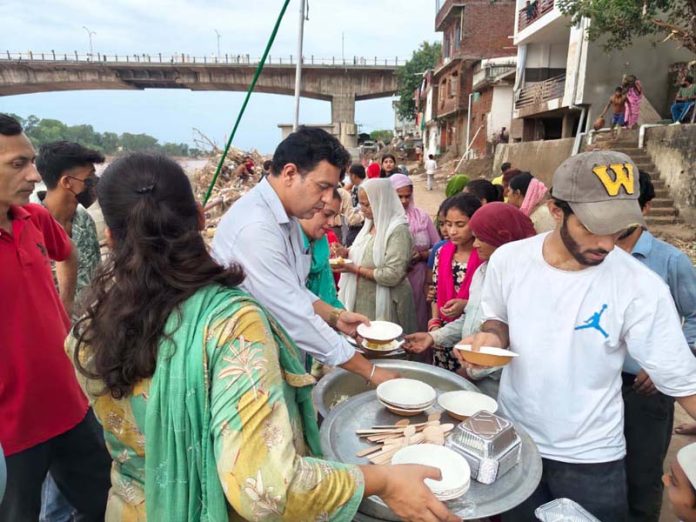 NAUP president, Sandeep Singh serving flood hit people in Jammu on Saturday.