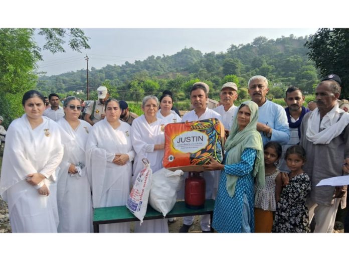 Brahma Kumaris distributing relief material to flood affected people in Kathua on Friday.