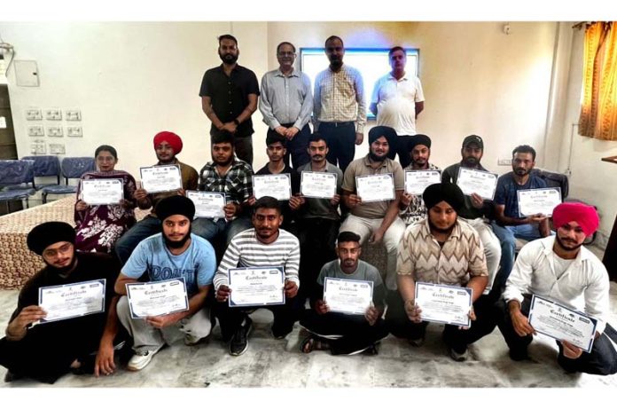 Candidates displaying certificates they got after completing 'Solar PV Installation Technician Training' at NITS Polytechnic, Miran Sahib.