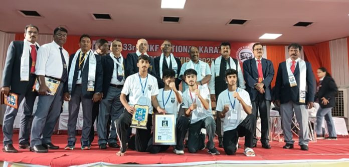 Winners posing with their medals alongside dignitaries during 33rd National Karate Championship 2025.