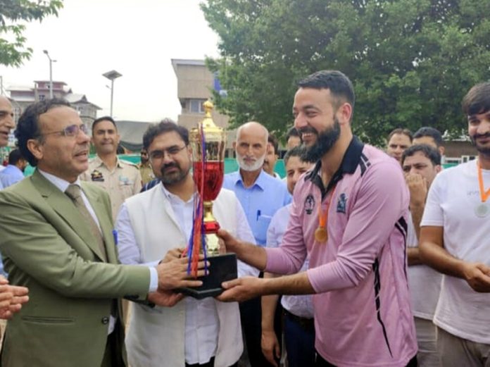 Minister for Sports Satish Sharma presenting trophy to the captain of winning team at Srinagar on Tuesday. Minister for Sports Satish Sharma presenting trophy to the captain of winning team at Srinagar on Tuesday.