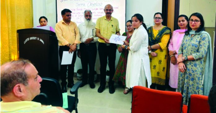A student receiving certificate from dignitaries.