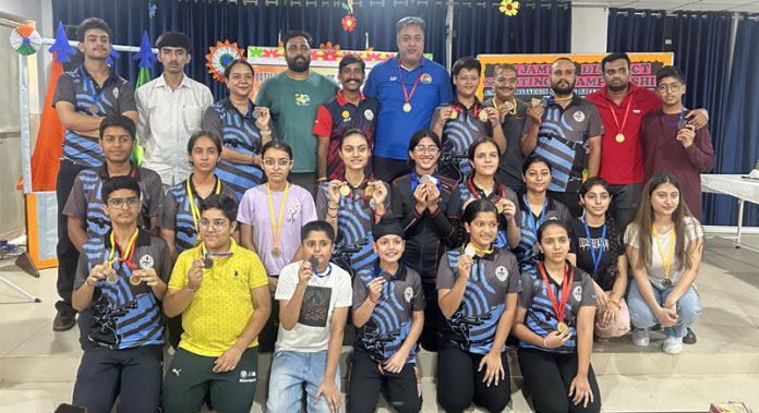Winners posing along with certificates during a programme.