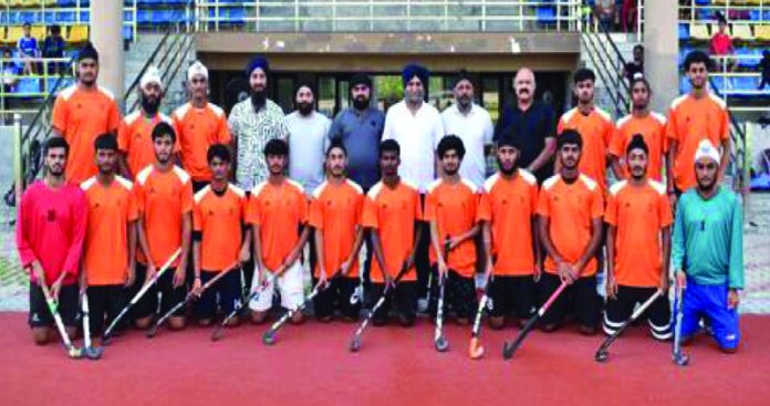 Selected J&K Sub Junior Men's Hockey team posing for group photograph along with dignitaries.