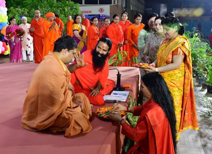 Swami Ramdev blessing Acharya Balkrishan during his birthday celebrations.