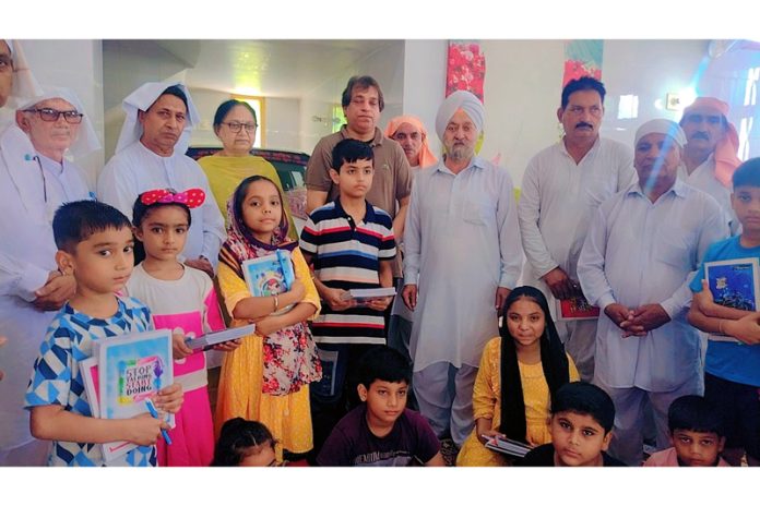 Members of Udas Marg Sanstha distributing stationery items during a function in Jammu.