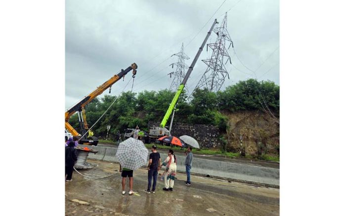 PDD engineers and ground staff alongwith machinery busy in restoration work of a key power transmission line in Jammu.