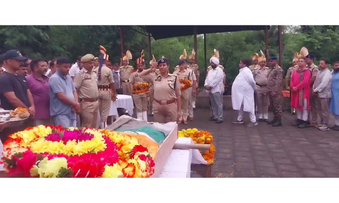 A police officer paying her last respect to PSI Shubam Seth in Jammu on Tuesday.
