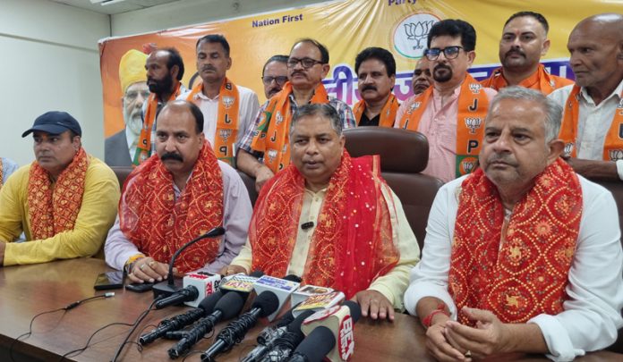 J&K BJP president, Sat Sharma and other senior leaders talking to reporters during a joining programme at Jammu on Tuesday. — Excelsior/Rakesh