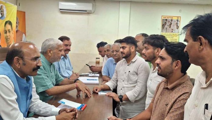 BJP MLAs, Sham Lal Sharma and Mohan Lal Bhagat listening public grievances at party office on Friday.