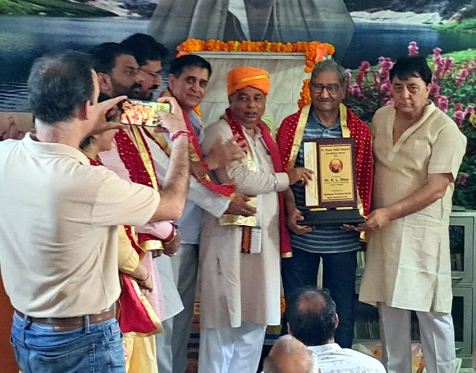 Dr R L Dhar being presented Pt Prem Nath Shastri Excellence Award 2025 by BJP president Sat Sharma and other dignitaries at Jammu on Sunday. Dr R L Dhar being presented Pt Prem Nath Shastri Excellence Award 2025 by BJP president Sat Sharma and other dignitaries at Jammu on Sunday.