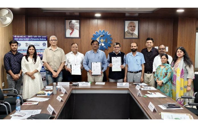 Prof Manoj Singh Gaur and Dr Zabeer Ahmed displaying copies of tripartite MoU signed among IIT Jammu, CSIR-IIIM and innovative start-ups.