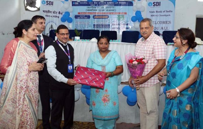 Dignitaries and beneficiaries during a financial inclusion camp organised at Ram Darbar Chandigarh on Friday. Dignitaries and beneficiaries during a financial inclusion camp organised at Ram Darbar Chandigarh on Friday.