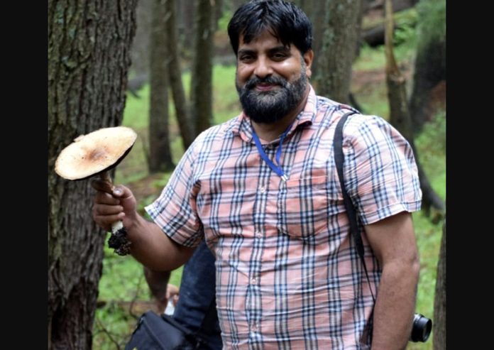 Dr Faisal Mushtaq Kichloo displaying rare mushroom species.