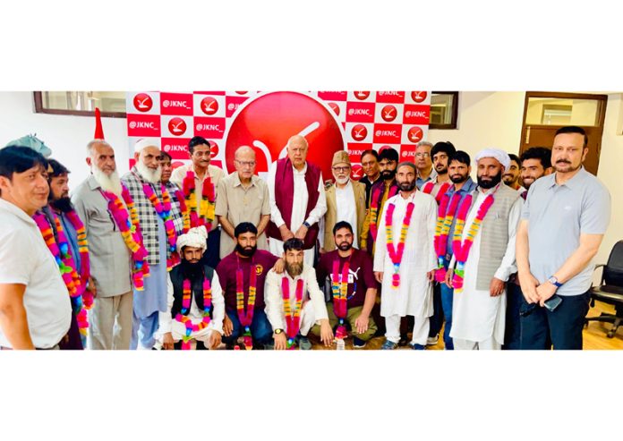 NC president Dr Farooq Abdullah welcoming new entrants into party fold at Srinagar on Monday.