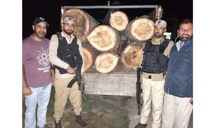 Police and Forest Department officials with the seized illegally-felled Deodar wood in Handwara town —Excelsior/ Aabid Nabi Police and Forest Department officials with the seized illegally-felled Deodar wood in Handwara town —Excelsior/ Aabid Nabi