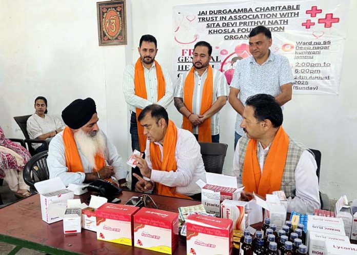 A doctor examining a patient during a free medical check up camp at Deep Nagar on Monday.