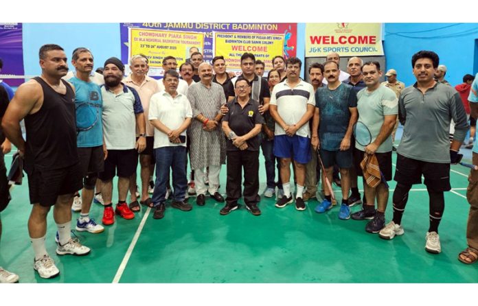 Dignitaries posing with veteran badminton players at MA Stadium, Jammu.