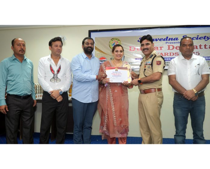 Dignitary presenting award during a programme.