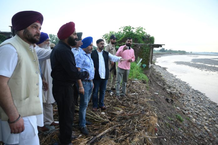 Minister Satish Sharma alongwith officials during visit to flood affected area of Jammu district on Saturday.
