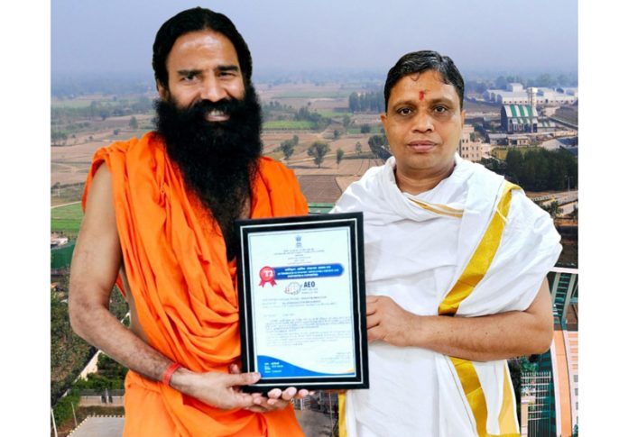 Swami Ramdev flanked by Acharya Balkrishna display the AEO Tier-2 Certificate conferred to Patanjali. Swami Ramdev flanked by Acharya Balkrishna display the AEO Tier-2 Certificate conferred to Patanjali.