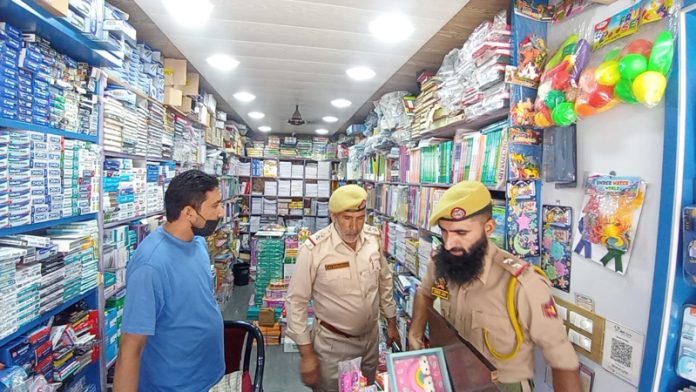 Police inspecting bookshop in Anantnag on Thursday. -Excelsior/Sajad Dar