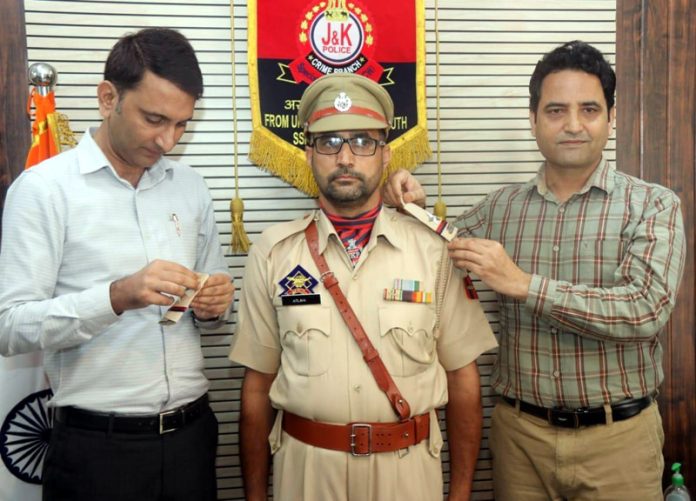 Newly promoted officer being decorated by SSP SCW Crime Branch Sanjay Parihar on Wednesday.