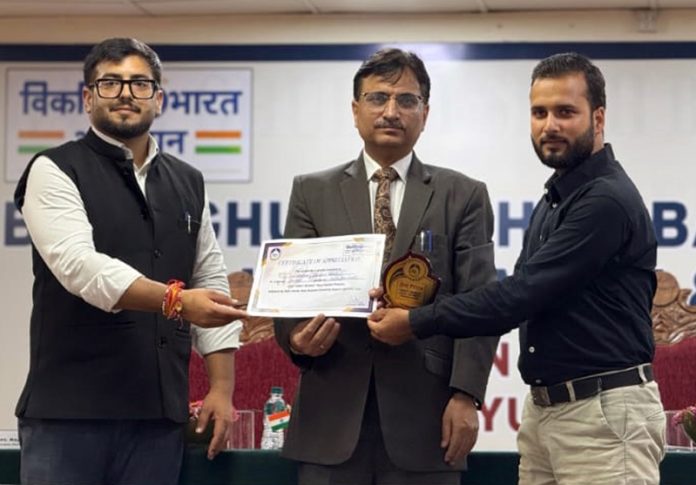 Abhishek Sharma awarding participation certificates during function at BGSBU.