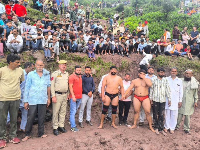 Spectators and wrestlers during mega dangal at Panchayat Dangakote in Reasi district.