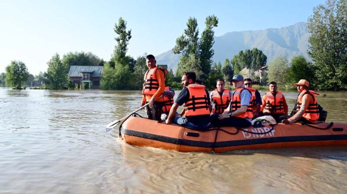 CM Omar Abdullah visiting flood-hit areas in a boat.
