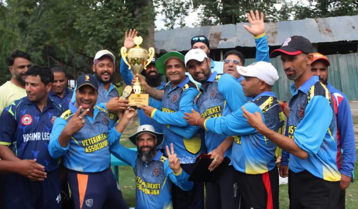 Winning team posing along with trophy. Winning team posing along with trophy.