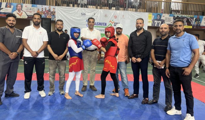 Wushu players posing along with chief guest during inaugural event in Srinagar. Wushu players posing along with chief guest during inaugural event in Srinagar.