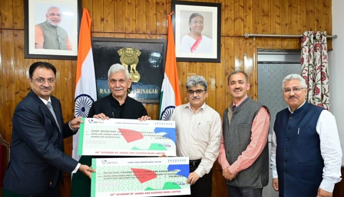 MD and CEO, J&K Bank, Amitava Chatterjee presenting two dividend cheques of Rs 122.85 crore and Rs 7.92 Crore to LG Manoj Sinha at Raj Bhawan, Srinagar. MD and CEO, J&K Bank, Amitava Chatterjee presenting two dividend cheques of Rs 122.85 crore and Rs 7.92 Crore to LG Manoj Sinha at Raj Bhawan, Srinagar.