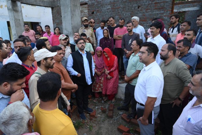 Minister Satish Sharma visiting flood affected areas of Chowki Choura on Monday.
