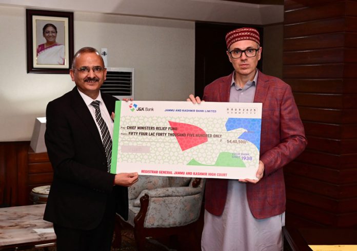 Principal Secretary to CJ M K Sharma handing over relief cheque to CM on Monday. Principal Secretary to CJ M K Sharma handing over relief cheque to CM on Monday.