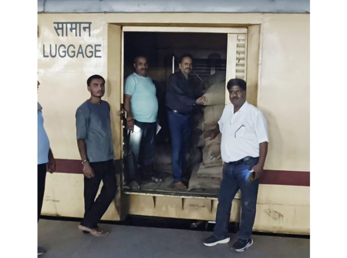 Railway officials posing with the relief material in flood special train, started from Jammu on Monday.