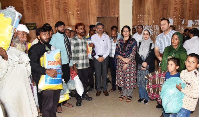 DC Udhampur Saloni Rai distributing relief material to rain-affected families on Wednesday.