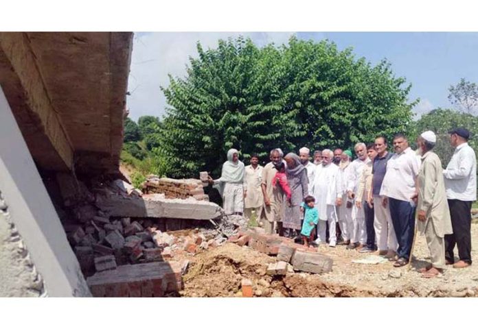 Senior NC leader Ajay Kumar Sadhotra assessing loss of houses due to land sinking at Kheri (Raipur), Jammu.