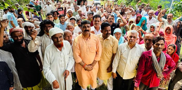 Senior leader, Pawan Khajuria during distribution of relief among rain hit people in Ghar Panchayat of Udhampur East constituency on Tuesday