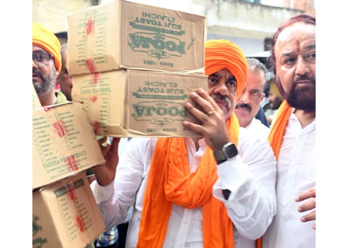BJP national general secretary, Tarun Chugh distributing relief among flood hit victims in Tarn Taran on Wednesday.