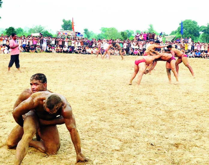 Wrestlers in action during annual Dangal at Gurha Brahmana, Akhnoor in Jammu. Wrestlers in action during annual Dangal at Gurha Brahmana, Akhnoor in Jammu.