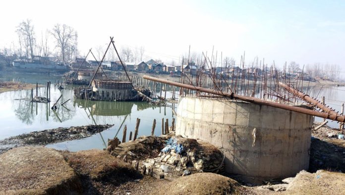 The underconstruction bridge over river Jhelum at Guzhama, Ganderbal on which work has been abandoned years back.