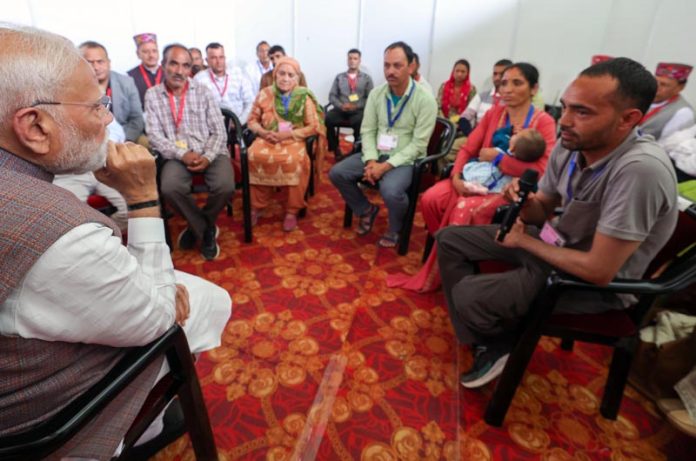 Prime Minister Narendra Modi meets flood-affected people in Himachal Pradesh on Tuesday.(UNI)