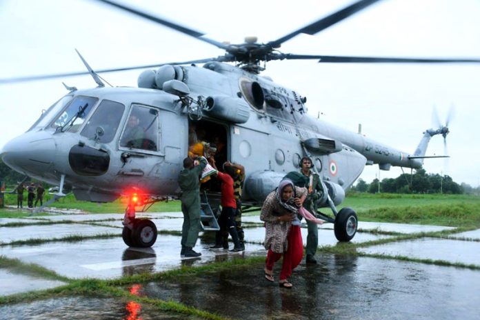 BSF personnel rescue civilians trapped in flash floods in Chenab River at Garkhal village, Akhnoor in Jammu on Wednesday.